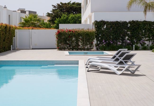 Swimming pool and sun loungers