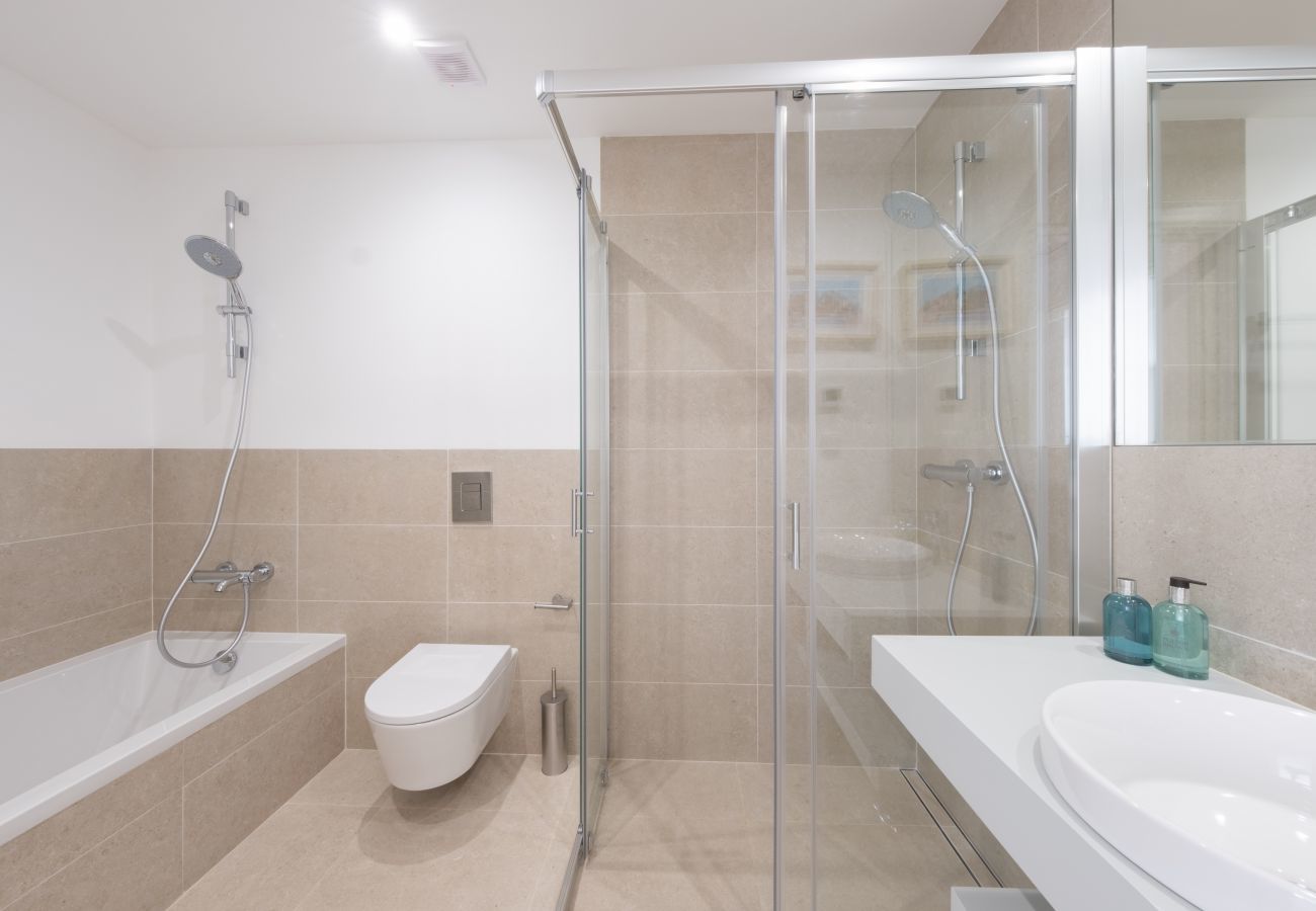 Bathroom with shower and bathtub